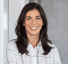 A woman with long hair and a white shirt.